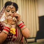 Elegant Indian bride adorned in mehndi and traditional saree with exquisite jewelry.